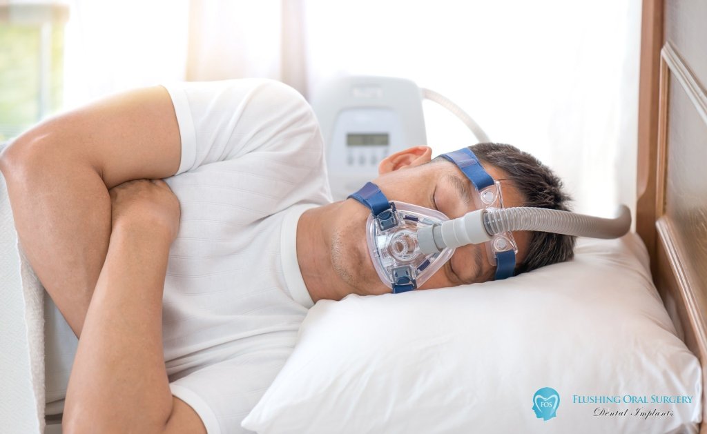 man sleeping while wearing CPAP mask